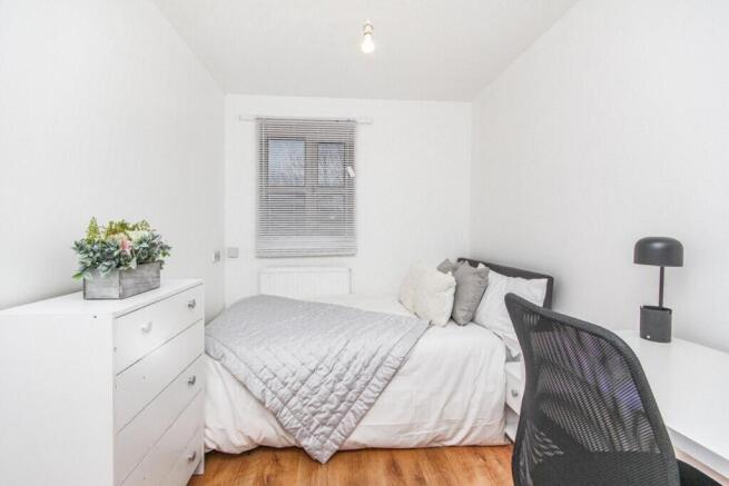 A beautifully arranged double bedroom featuring...