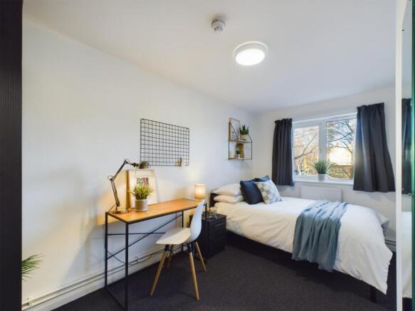 A bright and spacious double bedroom featuring ...