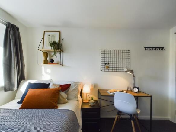 A bright and inviting double bedroom with moder...