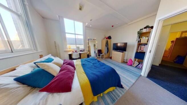 A spacious and brightly lit large double bedroo...