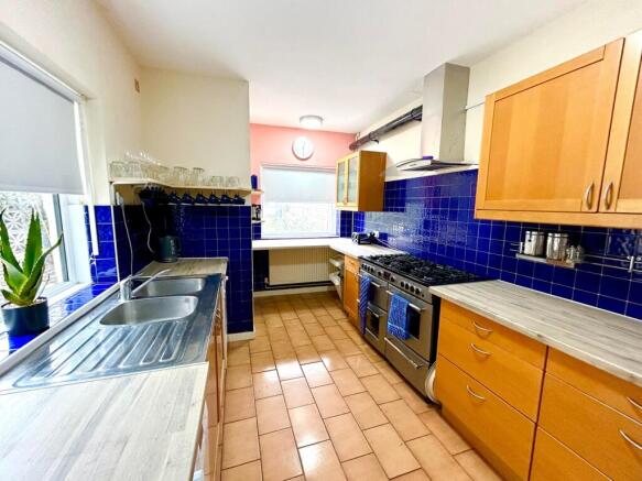Spacious kitchen featuring modern cabinetry, am...