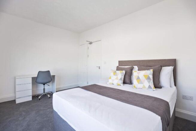 Bright and spacious double bedroom featuring a ...