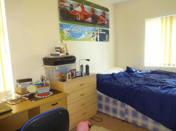 A bright and inviting double bedroom featuring ...