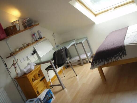 This charming double bedroom features a cozy la...