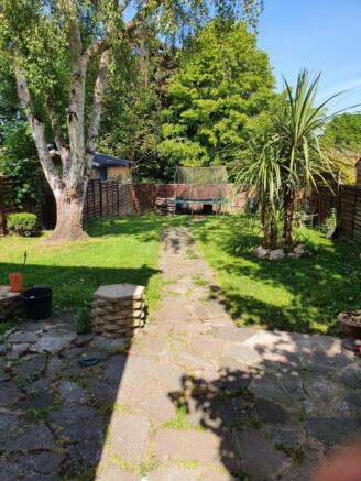 A beautifully maintained garden featuring a lus...