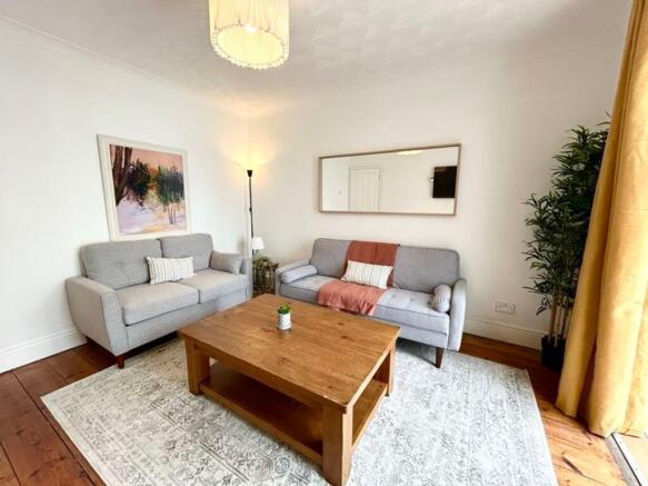 A bright and inviting large modern living room ...