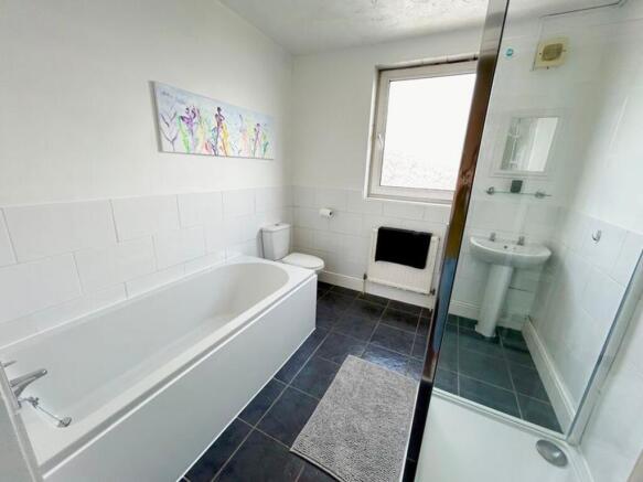 A spacious and bright large bathroom featuring ...
