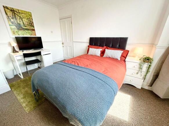 A cozy double bedroom featuring a comfortable b...