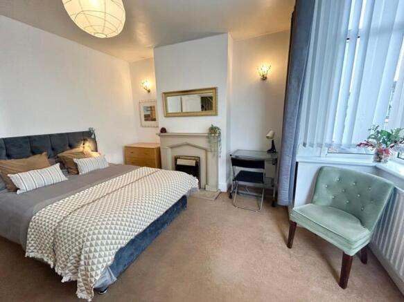 A spacious and inviting double bedroom featurin...