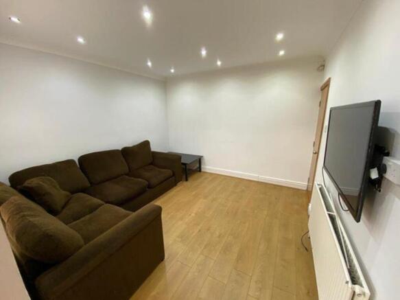 A spacious and tidy living room featuring moder...