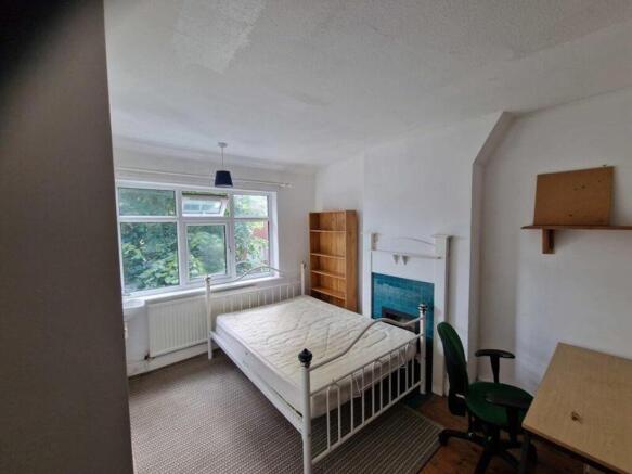 A bright and spacious double bedroom featuring ...