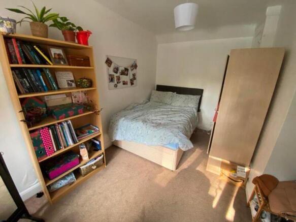 A bright and inviting double bedroom with ample...