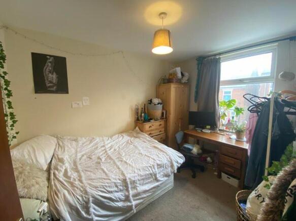 A cozy and well-lit double bedroom with ample s...