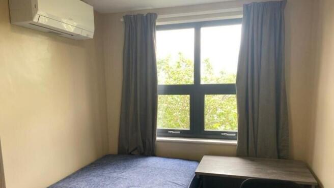 A bright and cozy double bedroom featuring a st...