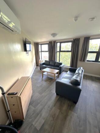 A bright and spacious living room featuring lar...