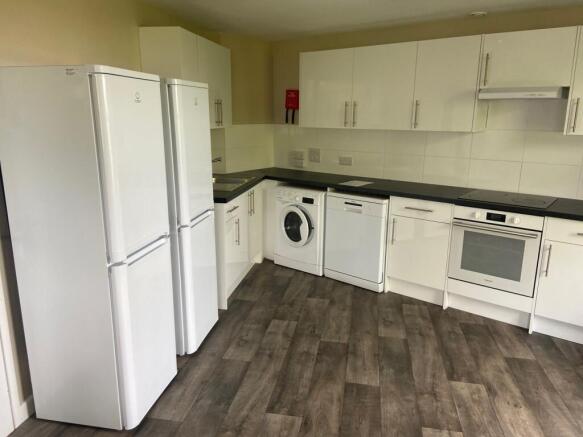 Modern kitchen featuring ample storage with sle...