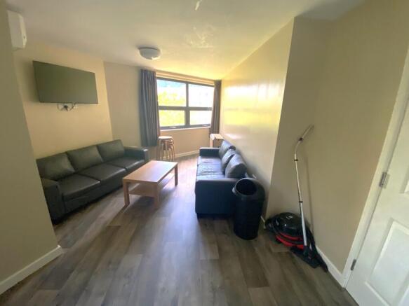A bright and inviting living room featuring com...