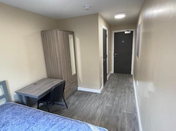 Spacious double bedroom featuring a comfortable...