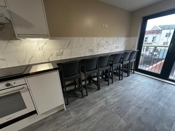 This modern kitchen features a sleek design wit...