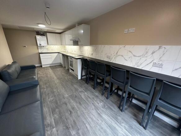 A modern kitchen featuring sleek cabinetry and ...