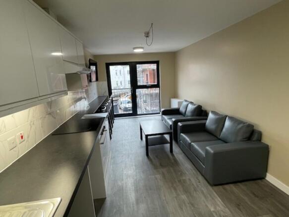 Spacious and modern living room featuring styli...