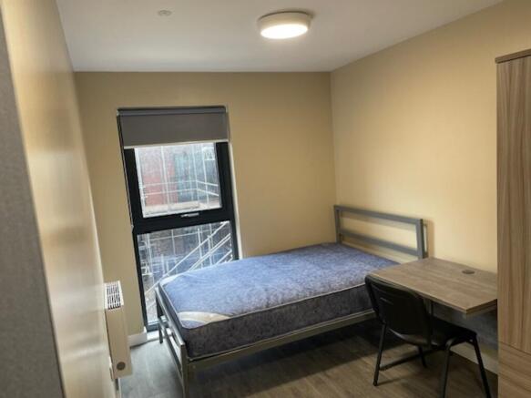 Spacious double bedroom featuring a comfortable...