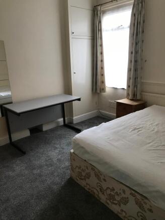 A cozy double bedroom featuring a comfortable b...
