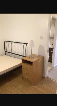Cozy double bedroom featuring a stylish metal b...