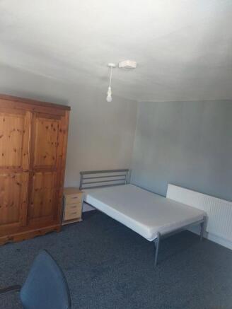 Spacious double bedroom featuring a fitted ward...