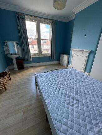 A spacious and bright double bedroom featuring ...