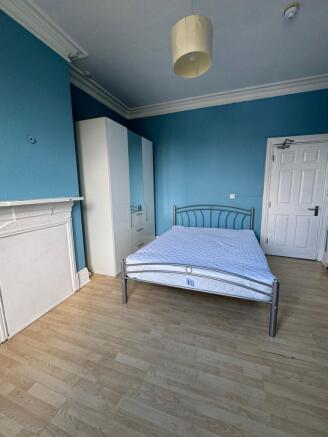 A bright and spacious double bedroom featuring ...