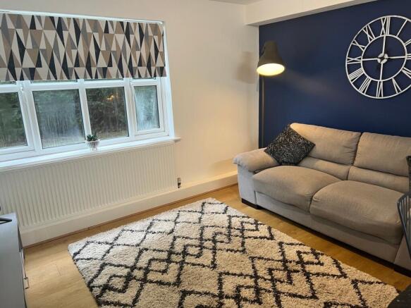 A cozy living room featuring a stylish gray sof...