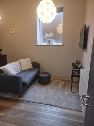 This contemporary living room features a cozy s...