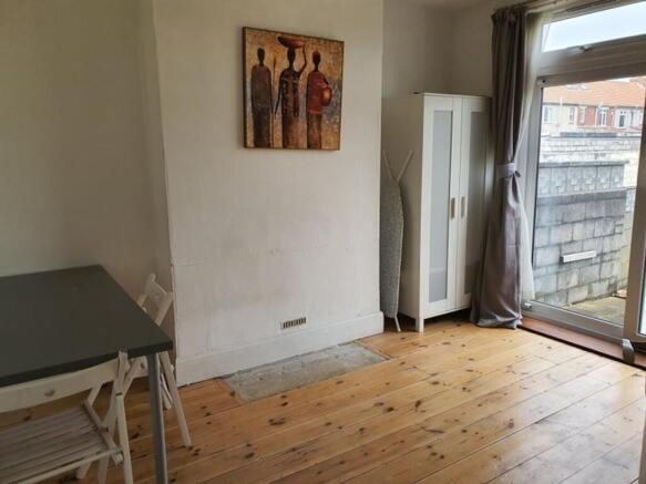 A cozy living room featuring warm wooden floors...