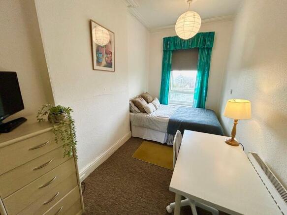 Cozy double bedroom featuring large windows tha...