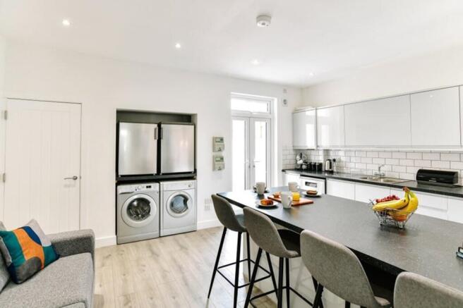 Modern kitchen featuring sleek cabinetry, ample...