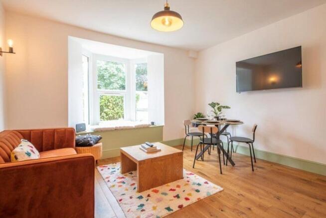 This inviting living room features a cozy orang...