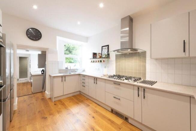 Spacious and modern kitchen featuring sleek cab...