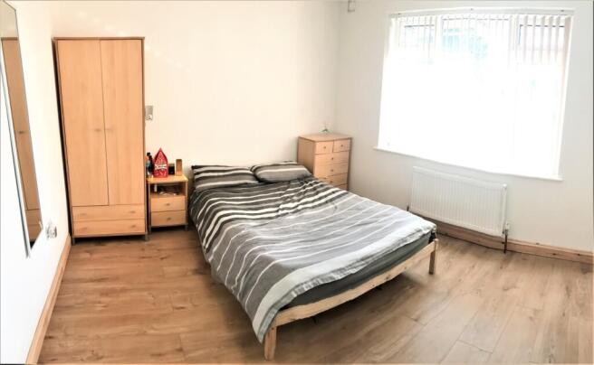Bright and spacious double bedroom featuring a ...