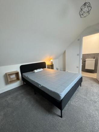This inviting double bedroom features a modern ...