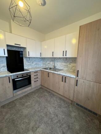 A modern kitchen featuring sleek cabinetry and ...