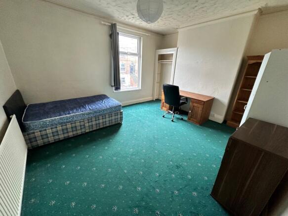 Spacious double bedroom featuring a comfortable...