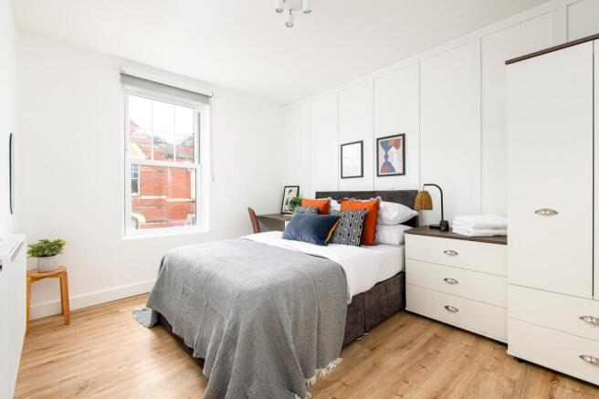 A beautifully arranged double bedroom featuring...