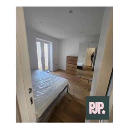 This spacious double bedroom features ample nat...