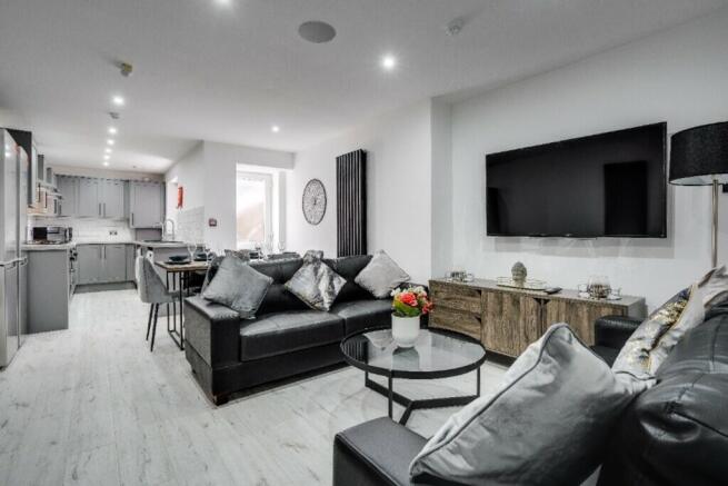 A spacious and stylish modern living room, perf...
