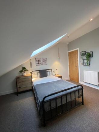 This charming double bedroom features a cozy la...