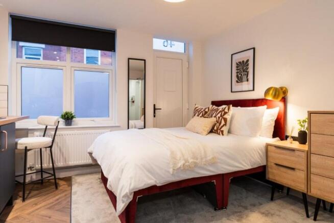 Stylishly designed double bedroom featuring a p...