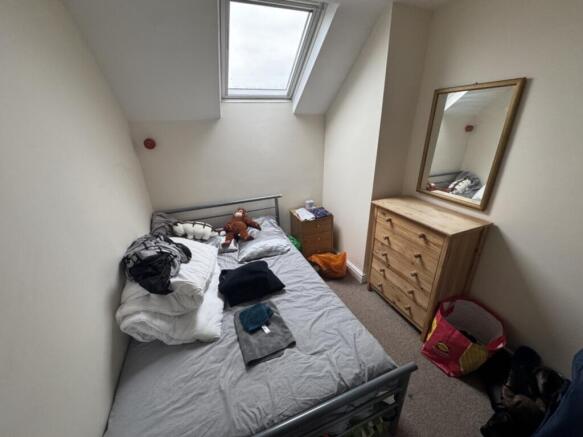 Cozy double bedroom featuring a comfortable bed...
