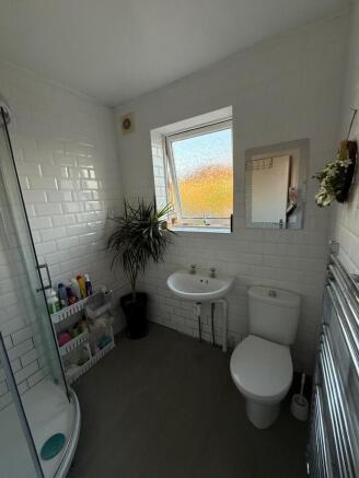 Bright and modern bathroom suite featuring a sp...