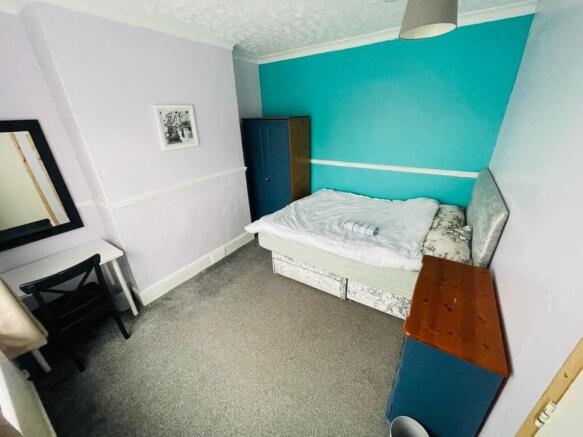 Cozy double bedroom featuring a comfortable bed...
